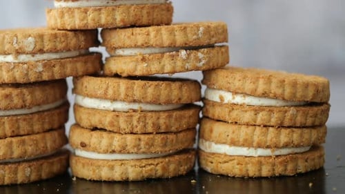 Delicious Sandwich Cookies Stacked on Table