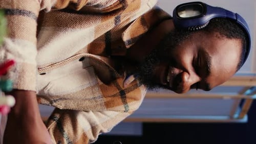 Vertical Video Zoom in on Man on Podcast Discussing with Guest During Marathon Stream