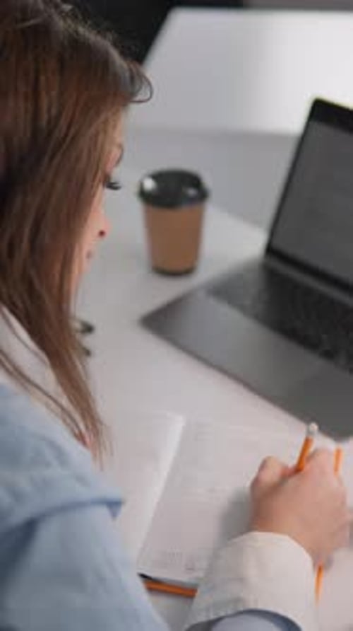 Woman at Desk Writing in Notebook