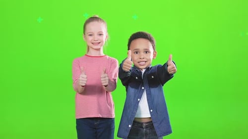 Smiling Children Giving Thumbs Up on Green Screen