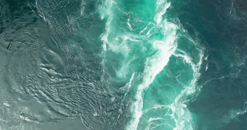 Aerial view of blue ocean water swirling