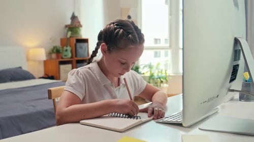 Young Girl Studying and Taking Notes at Home