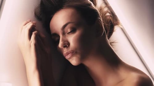 Woman Resting in Studio with Bright Lighting