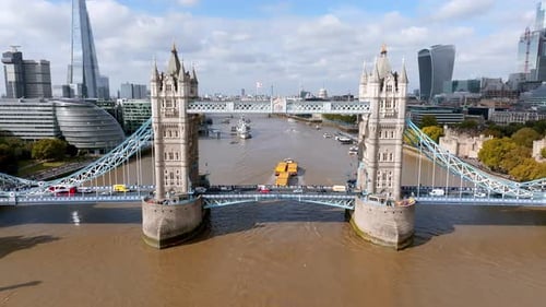 Cargo Boat Sailing Down the River Thames in London Right Under the Tower Bridge