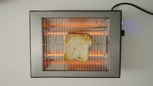Single Slice of Bread toasting in Toaster