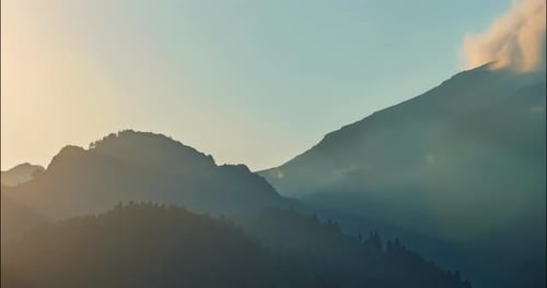 Mountains at Sunrise with Clouds and Golden Light