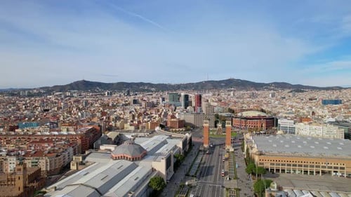 A long panoramic aerial drone rooftops view of southern part of city with roundabout in city center