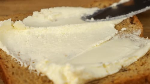 Butter Being Spread on Bread Slice, Close Up