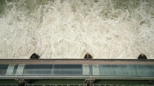 Water dam releasing huge amounts of water creating white foam