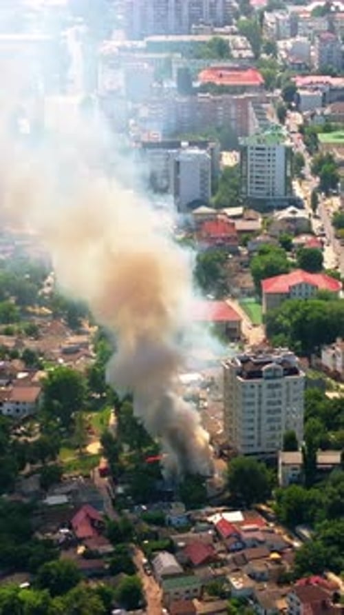 Aerial drone view of smoke coming out of a building in Chisinau, Moldova. Vertical