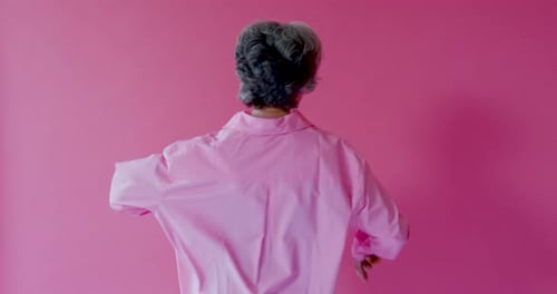 Elegant Senior Female Dancing and Looking to Camera in Studio