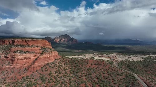 Majestic Red Rock Mountains Against Cloudscape On The Sky In Sedona, Arizona. Aerial Wide Shot