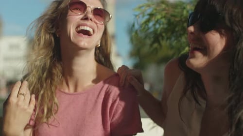 Two friendly and happy women laugh together