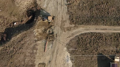 Aerial View of a Yellow Tractor That Performs Earthworks