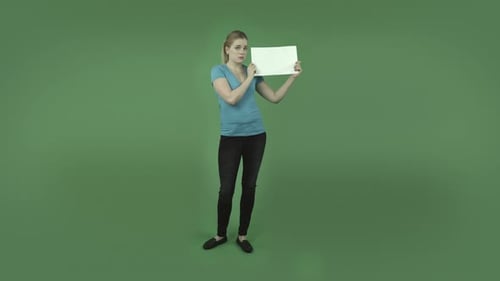 caucasian casual blond girl isolated on green upset with blank sign