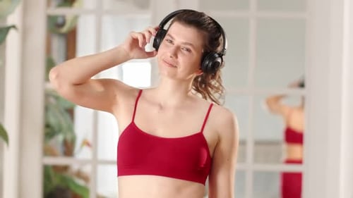 Woman Dancing with Headphones Indoors