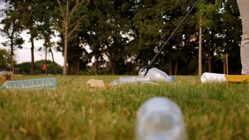 Collecting Trash and Plastic Waste in Park