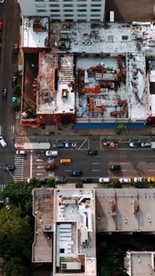Transport runs by the streets of New York. Car park on the top of the building. Aerial view.