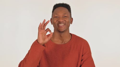 Young Man Smiling Giving OK Hand Gesture