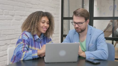 Business Colleagues Work Together at Office on Laptop