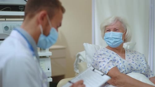 Cheerful Grey Haired Old Lady in Face Mask Recovering Illness at Hospital Enjoying Positive Results