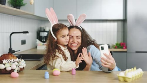 A Cheerful Family is Preparing for the Easter Holiday Using Smartphone to Video Calling