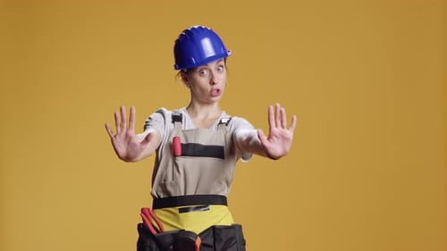 Portrait of Construction Worker Doing Stop Sign with Palm