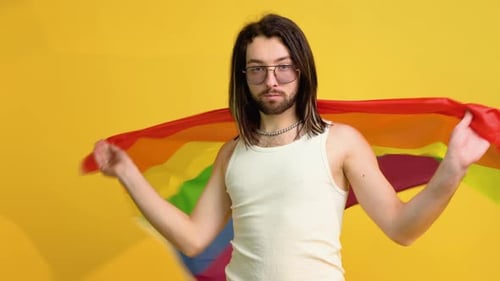 Person Proudly Posing with Rainbow Flag