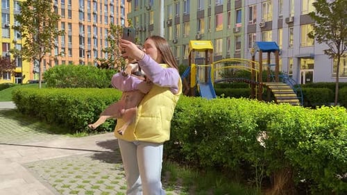 Young Woman Takes Selfie with Dog in City