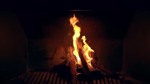 Crackling Fireplace Flames in Dark Home Interior