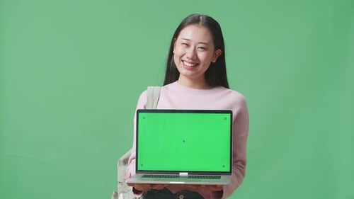 Asian Woman Student Showing Mock Up Laptop Green Screen On Green Screen Studio