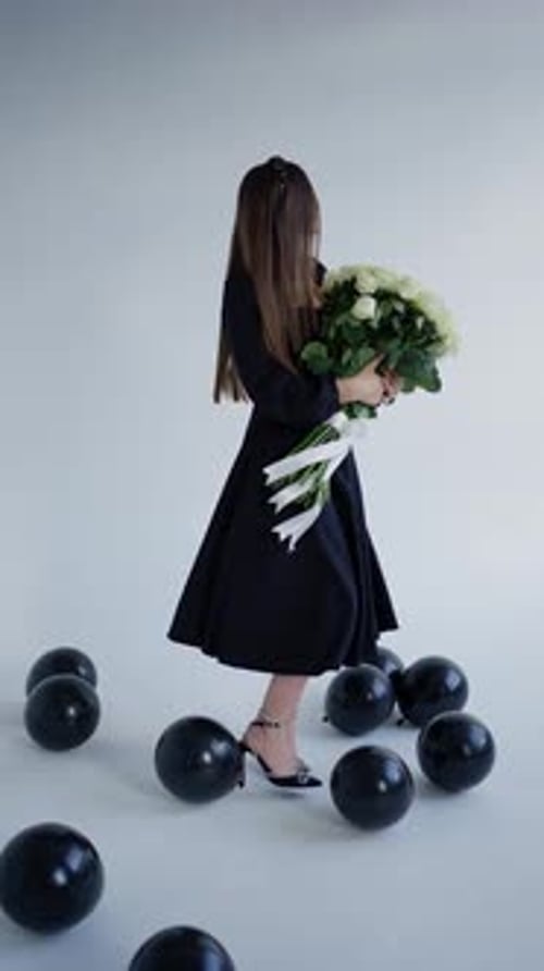 Brunette Woman with Bouquet Poses with Balloons