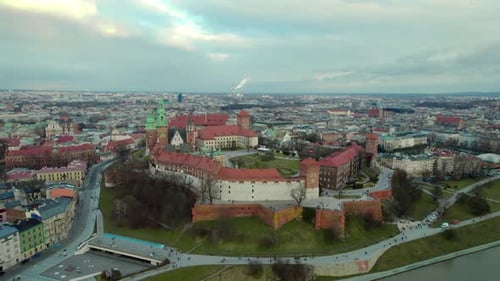 Aerial stablishing shot moving upwards revealing the city of Krakow, Poland, with the Wawel Royal Ca