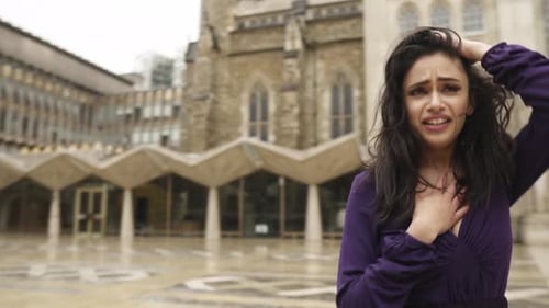 Heartbroken depressed alone indian young woman in gothic outfit near church lost no people empty str
