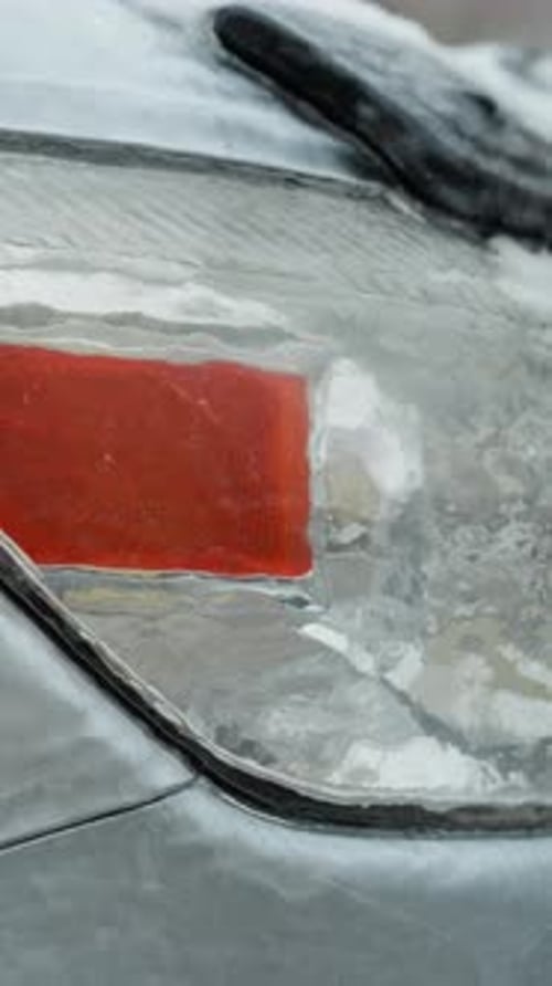 Icy Car Headlight in Winter Close Up