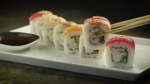 Eating Sushi Roll in Japanese Restaurant