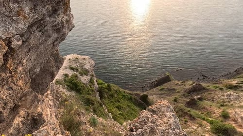 Sunset Over Calm Sea with Rocky Volcanic Cliff Abstract Nature Summer Ocean Sea Background Small