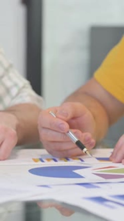 Close up of Male Hands Working on Documents, vertical video