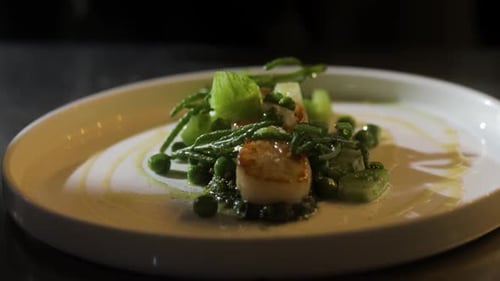 Gourmet Scallop Dish with Peas on White Plate