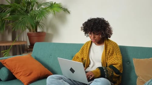 African American Girl Using Laptop at Home Office Looking at Screen Typing Chatting Reading Writing