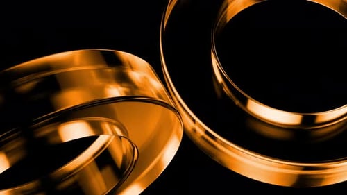 Golden rings rotating on black background