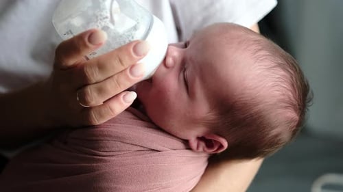 Baby Drinking Milk from Bottle Close Up
