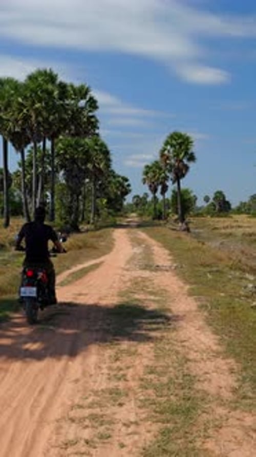 Vertical Static Motorcyclist Riding Away on Road