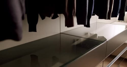 Minimalist Closet Design with Glass Topped Storage Dolly Shot