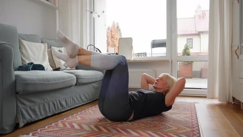Woman Doing Crunches Exercise at Home