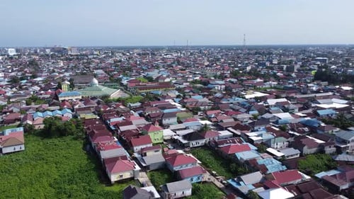 Aerial view of Banjarmasin city which is dense with housing, tall buildings and shopping centers