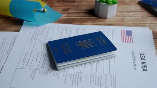 Close Up Shot of Person Identity Document Application for Moving to Usa and Ukrainian Passport