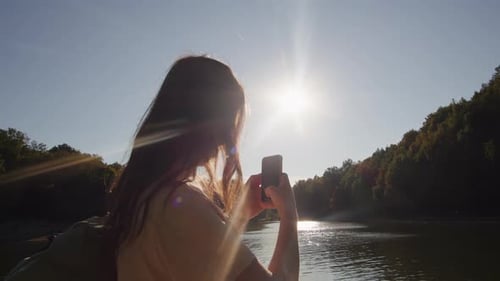 Young Woman in the Park with Cellphone Chatting Close Up Female is Taking Photo of the Lovely Pond