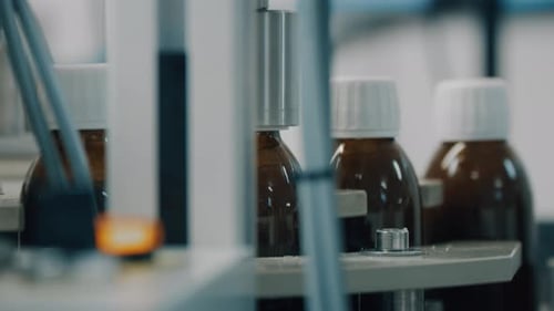 Glass Bottles Moving on Conveyor Belt