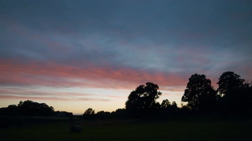 Golden Sunset over Rural Landscape with Trees